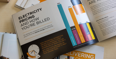 Photo of Aurora Energy's pricing guide, open on a page that reads: Electricity pricing and how you're billed.