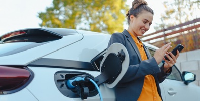 EV Charging Women On Phone 1200Px