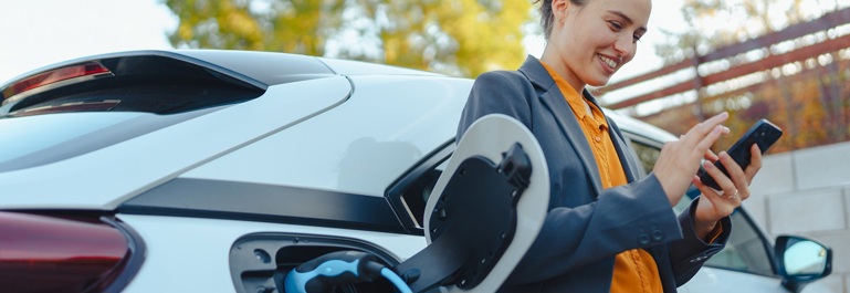 EV Charging Women On Phone 1200Px